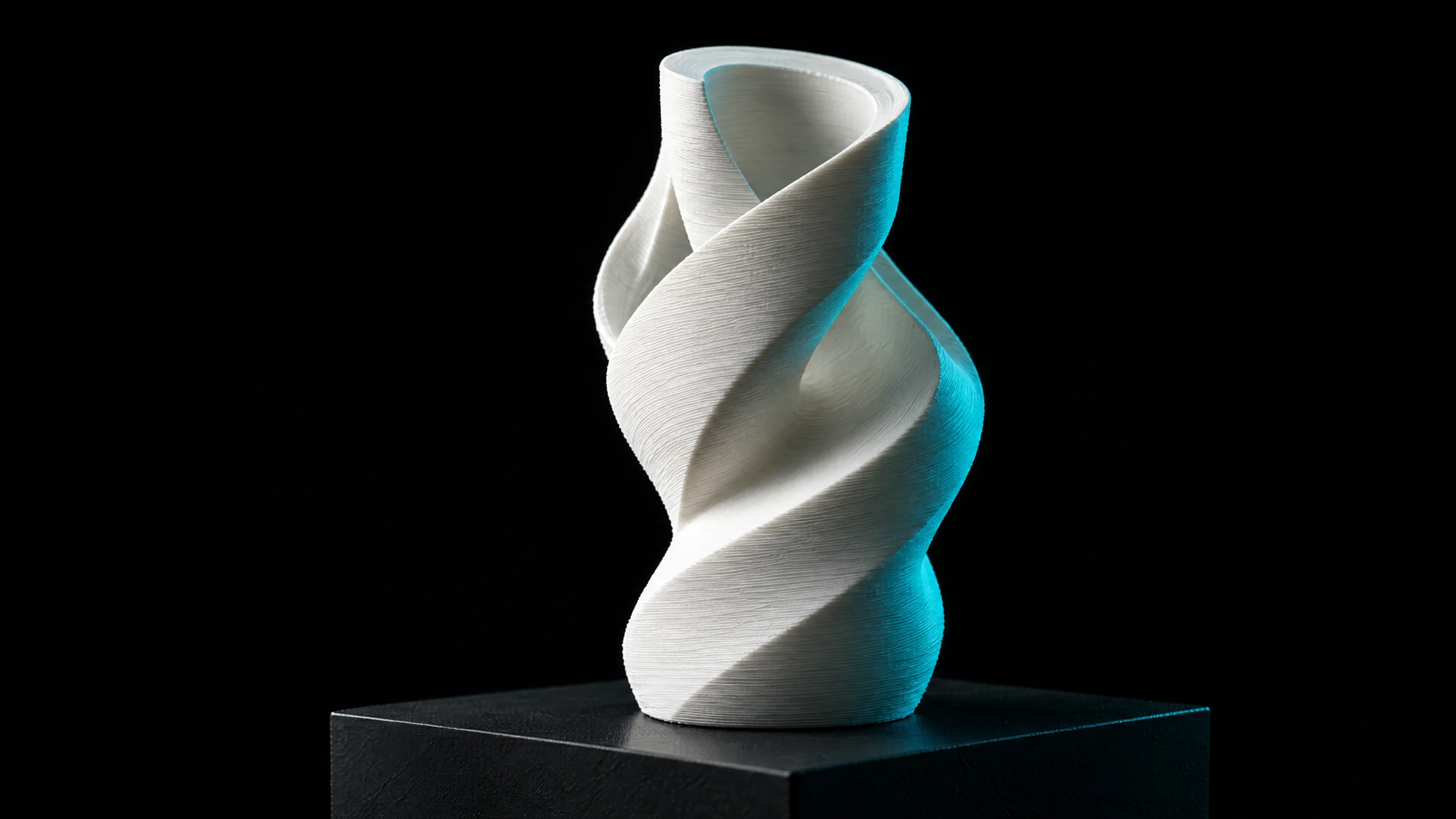 White spiral sculptural object on a black plinth