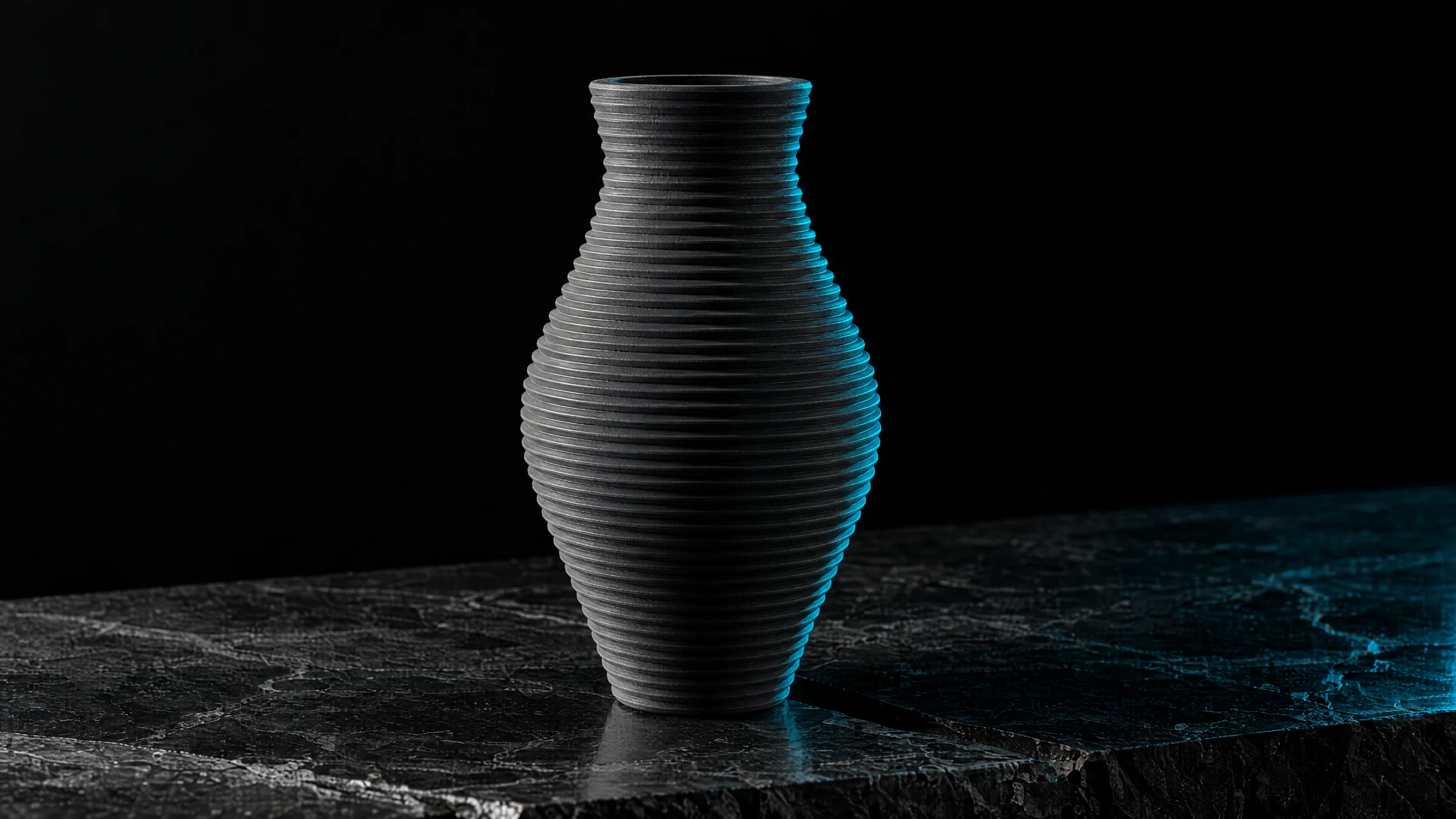 Dark vase with pronounced print rings on a dark stone